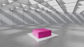 Pink rectangular box displayed on a pedestal in a modern, bright, minimalist showroom.