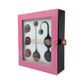 Set of kegel balls for pelvic floor training in a pink gift box with clear window display.