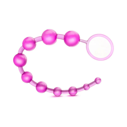Pink silicone beaded pleasure toy with retrieval ring on white background