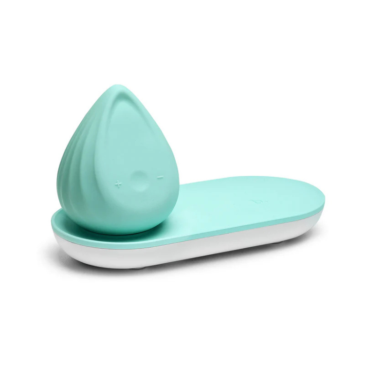 Mint green Biird Evii wellness massager on charging base, House of Vices premium toy