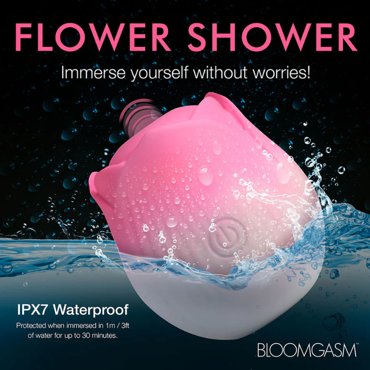 Pink rose-shaped waterproof stimulator partially submerged in water, House of Vices wellness store.