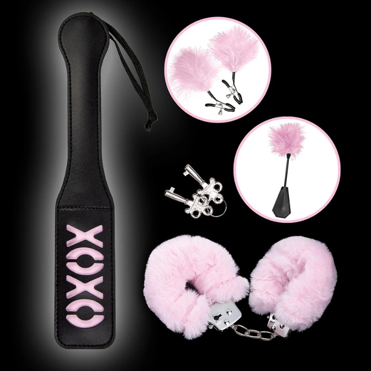 Pink and black bondage set with fluffy cuffs, feather tickler, and XOXO paddle, House of Vices wellness kit.