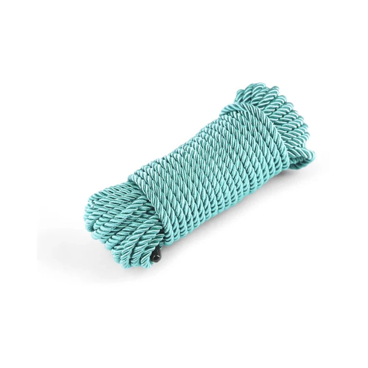 Coiled turquoise rope for bondage and sensory play on a white background