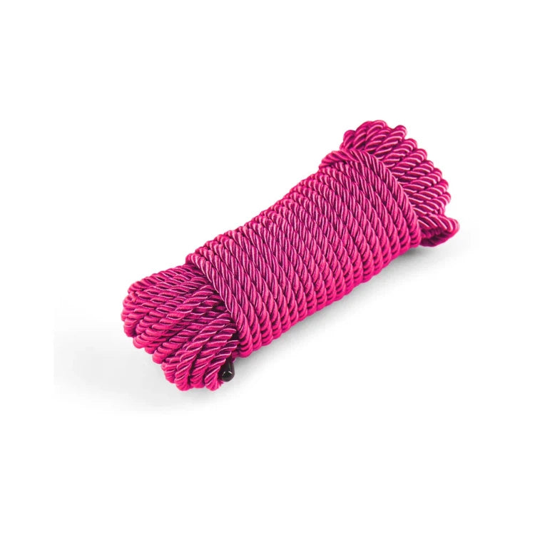 Coiled roll of bright pink braided bondage rope