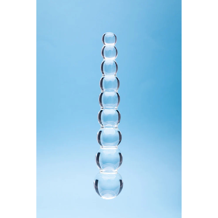 Clear glass beaded wellness wand on blue background, House of Vices premium adult toy