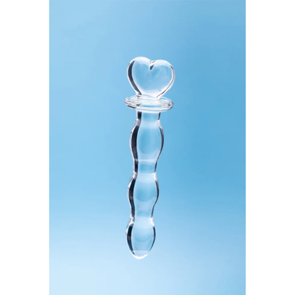 Clear glass toy with heart-shaped handle on light blue background, House of Vices wellness product