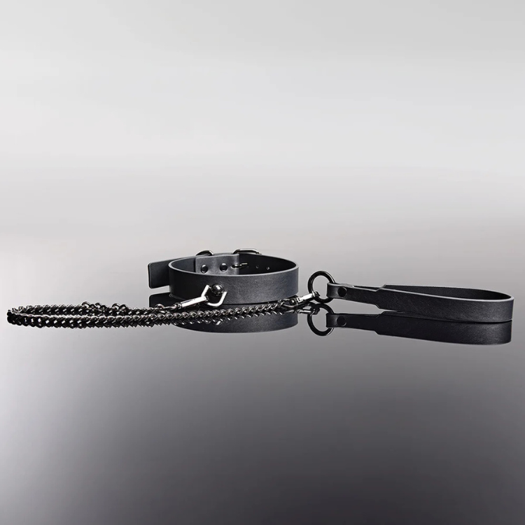 Grey adjustable pleasure collar with matching leash, chain detail, on reflective black surface