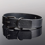 Grey Coquette branded collar with metal buckle on reflective surface, House of Vices wellness accessory