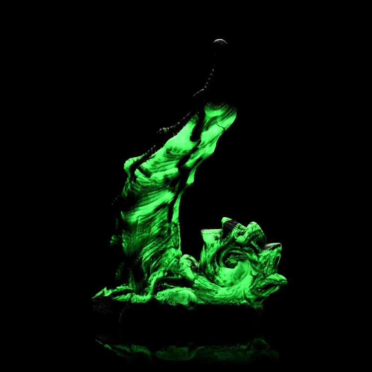 Glow-in-the-dark green textured adult toy sculpture against a black background