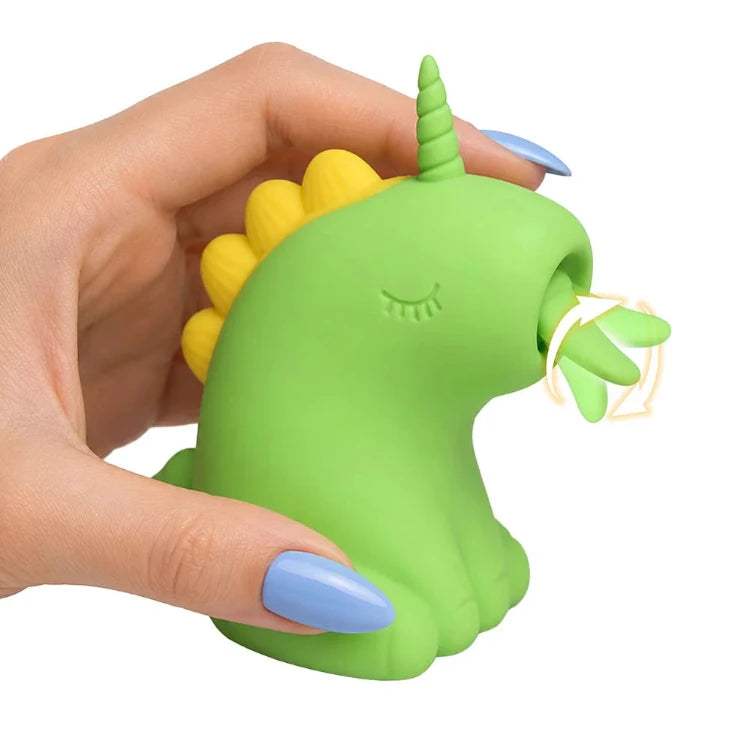 A hand holding the green XR Brands Creature Cuties Lickyhorn licking stimulator toy.