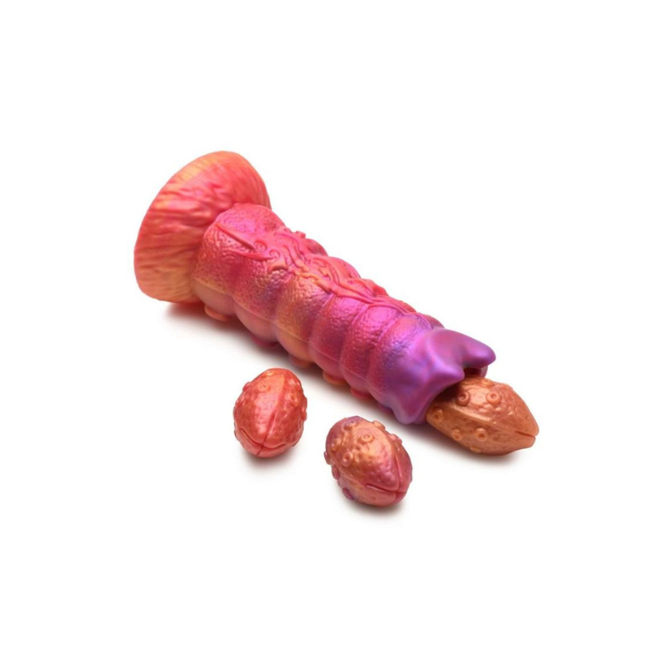 Colorful silicone fantasy dildo with textured details and three removable egg shapes on white