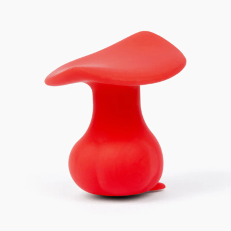 Red silicone mushroom-shaped wellness toy on white background from House of Vices