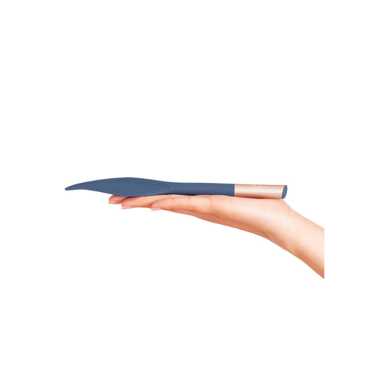 Blue silicone feather-shaped tickler with gold handle, held in hand, House of Vices wellness.