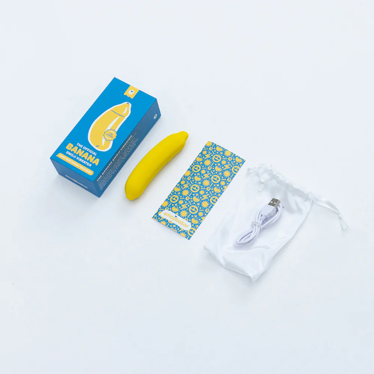 Emojibator banana set with box, yellow banana-shaped device, patterned card, USB cable, and pouch from House of Vices wellness store