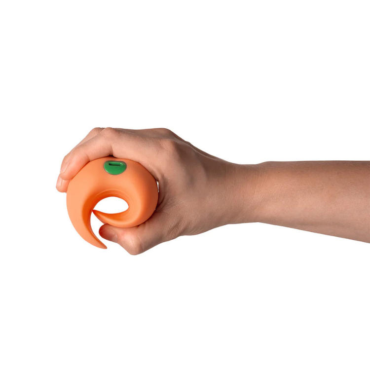 Hand holding orange peach-shaped wellness device from House of Vices, white background
