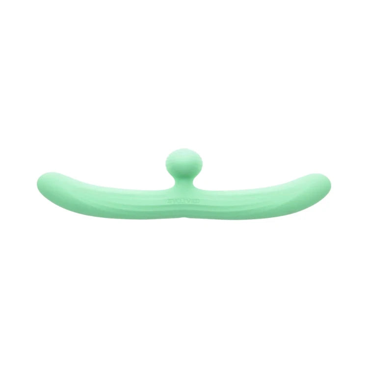 Mint green silicone curved pleasure toy with a central nub on a white background