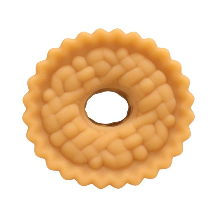 Close-up of a beige donut-shaped textured silicone sleeve on white background