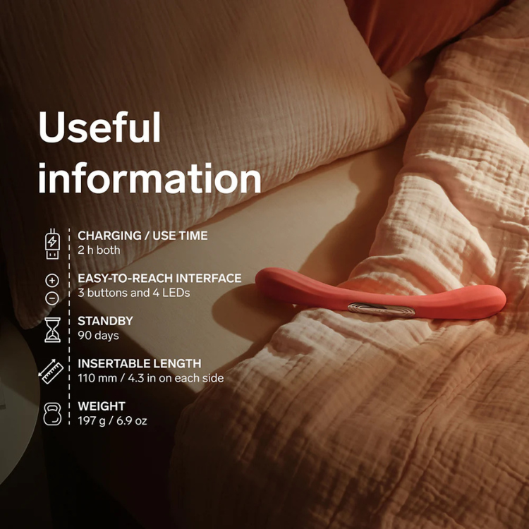 Red dual-ended adult toy with ergonomic shape on a beige bed, product info overlayed.