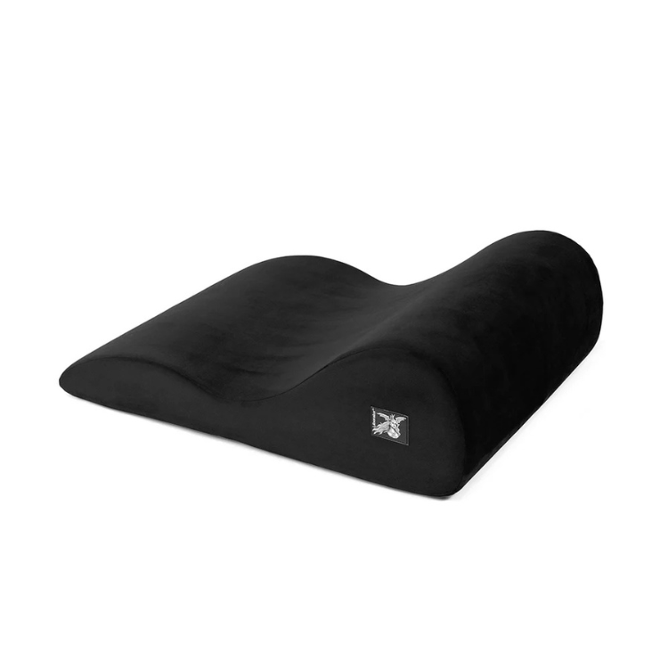 Black ergonomic foam positioning pillow with a wave contour design on white background