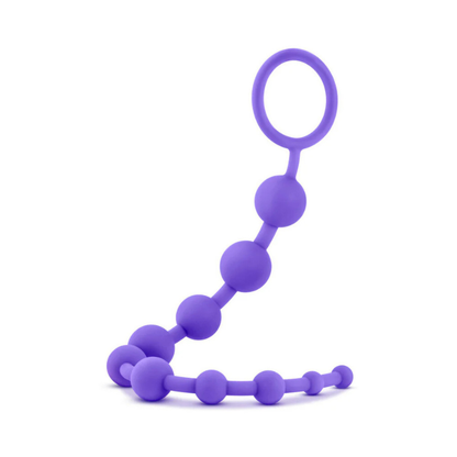Purple silicone 10-bead adult wellness toy with retrieval loop on white background