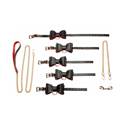 Black and red leather bow bondage set with gold chains, cuffs, collar, and leash