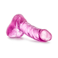 Pink realistic silicone adult wellness toy with textured surface, displayed on a white background.