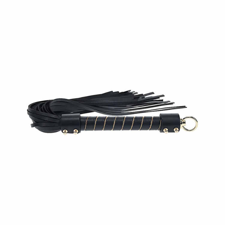 Black faux leather flogger with gold-accented handle and loop, adult wellness accessory.