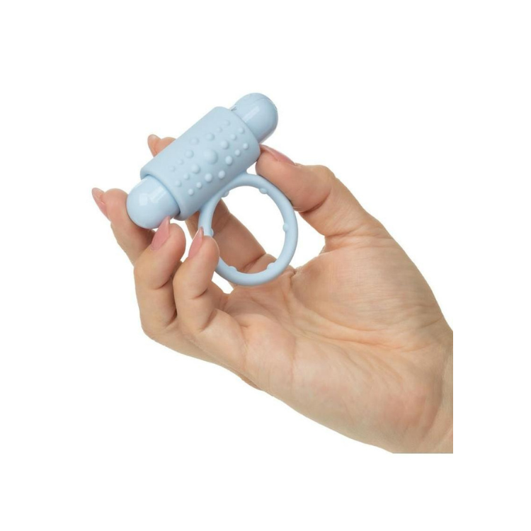 Light blue textured vibrating cock ring held in hand