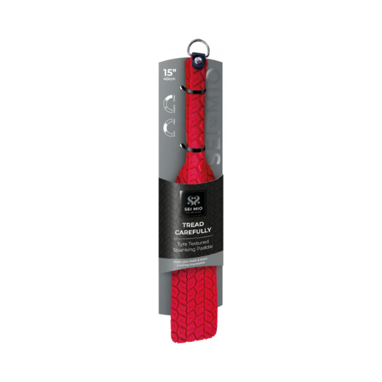 Red tyre-textured spanking paddle with wrist strap in retail packaging, 15 inch size