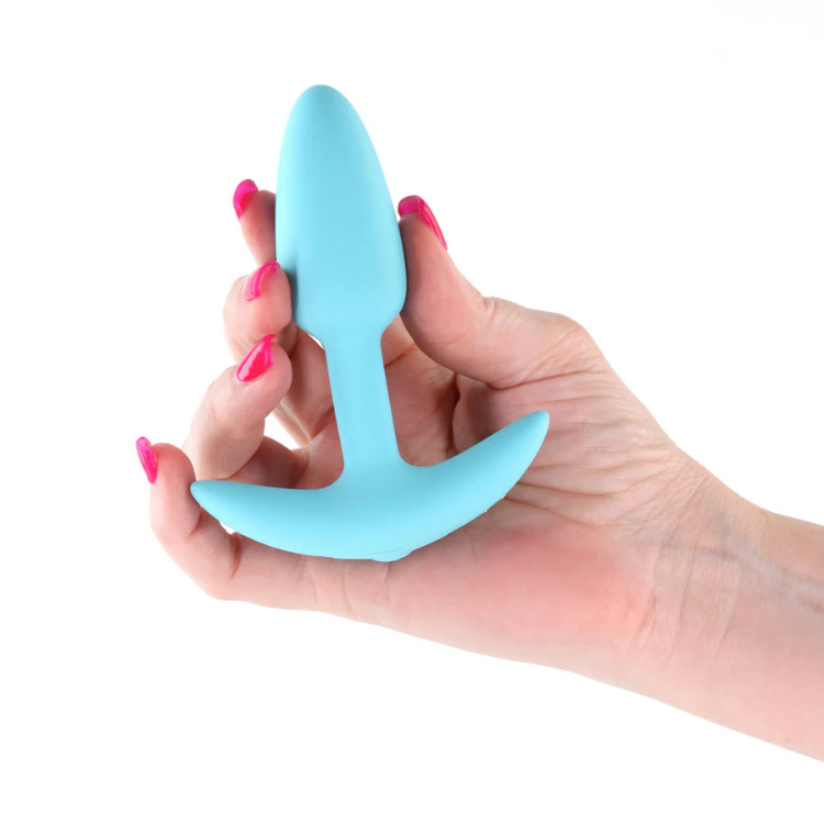 Hand holding a blue silicone personal wellness plug, featured at House of Vices
