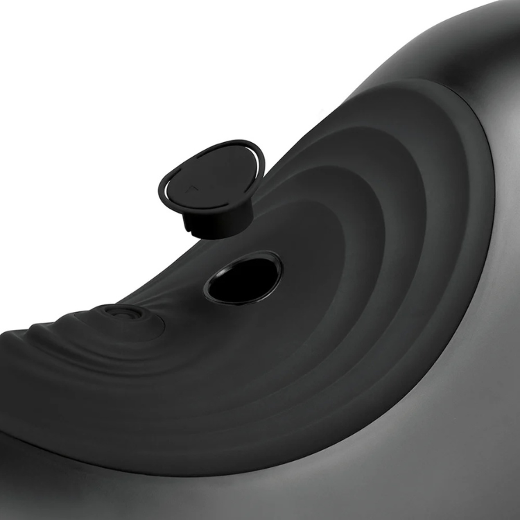 Close-up of a black saddle-shaped adult toy machine with smooth, contoured surface and plug opening