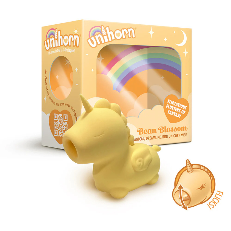 Yellow unicorn-shaped vibrator with packaging featuring rainbow and fantasy design elements.