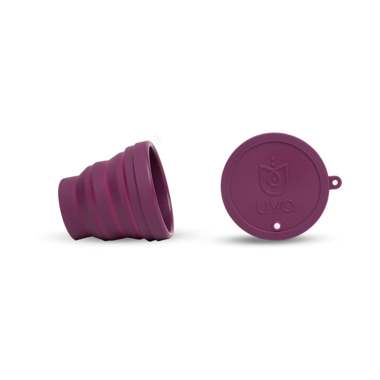 Purple collapsible menstrual cup and matching lid on white background